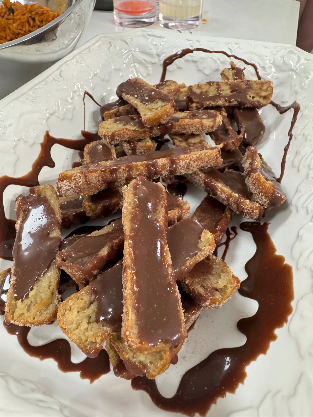 Fresh churros with chocolate sauce prepared in a client's kitchen