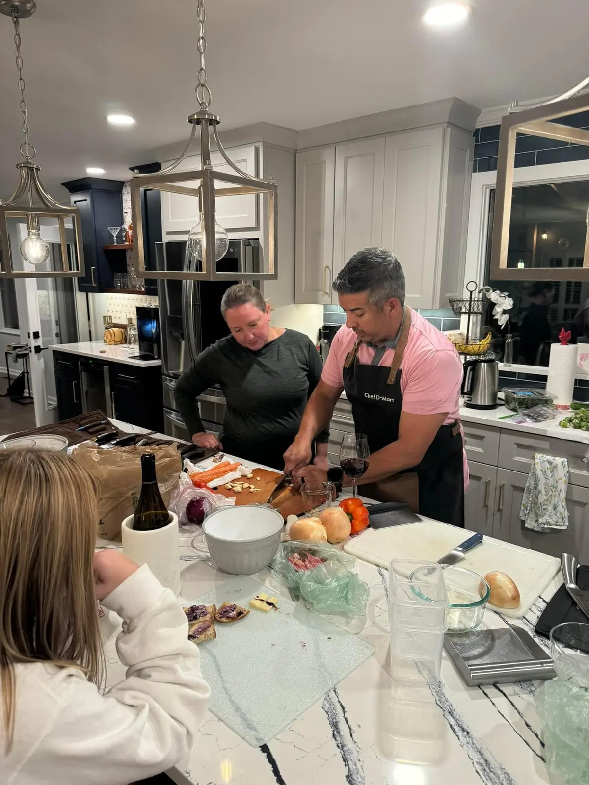 Chef D.Mart teaching a client in the kitchen he helped design