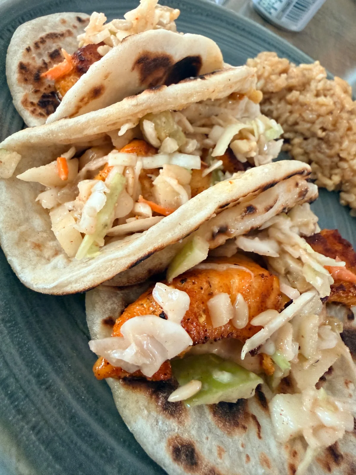 Crispy salmon fish tacos with apple slaw on homemade flour tortillas