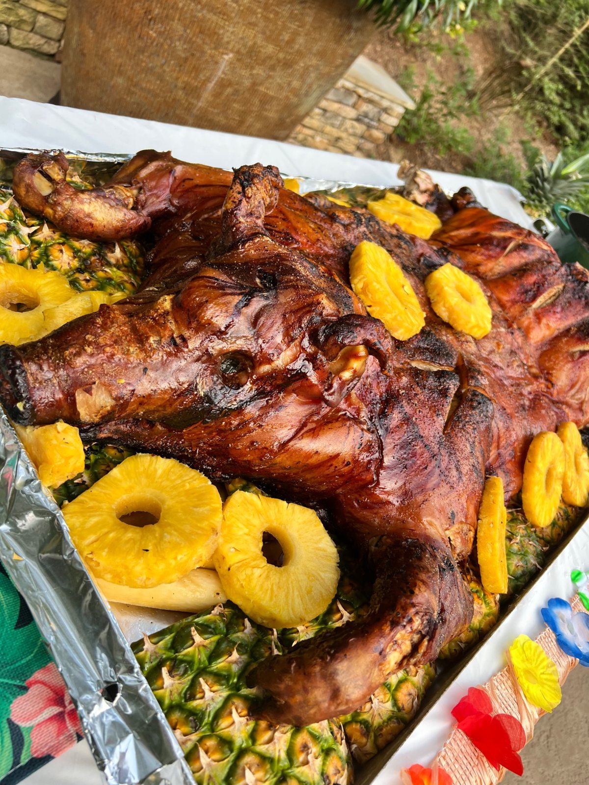 Close view of the roasted hog skin and bright pineapple garnish